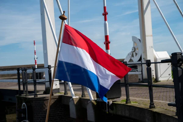Red white blue Dutch flag on boat in North Holland close up
