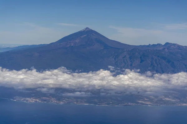 Flying propeller plane around Tenerife island with peak of Mount Teide, volcatic landscape, Canary islands, Spain