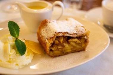 Avusturya tatlısı, krem şantili elmalı turta ve sıcak vanilyalı sos Viyana, Avusturya 'daki eski fırın kafede servis ediliyor.