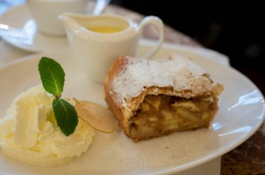Avusturya tatlısı, krem şantili elmalı turta ve sıcak vanilyalı sos Viyana, Avusturya 'daki eski fırın kafede servis ediliyor.