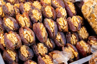 Turkish or arabic sweet dessert, ripe dried dadels with walnuts sweetened with syrup or honey, close up