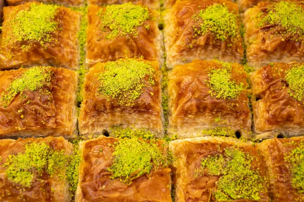 Turkish or arabic sweet dessert, baklava fistikli made from filo pastry, filled with chopped pistachio nuts and sweetened with syrup or honey, close up