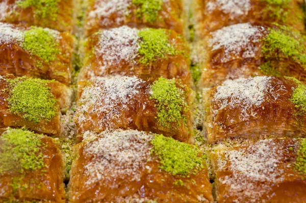 Turkish or arabic sweet dessert, baklava made from filo pastry, filled with chopped pistachio nuts and sweetened with syrup or honey, close up