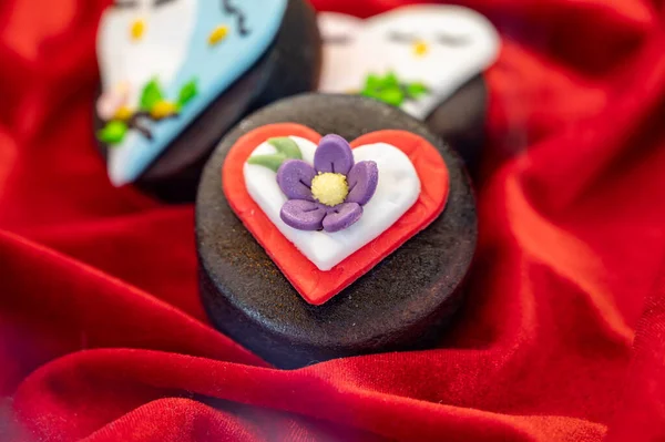 Food styling in bakery, wedding or happy valentine colorful cakes and candies decorated with chocolate hearts and flowers