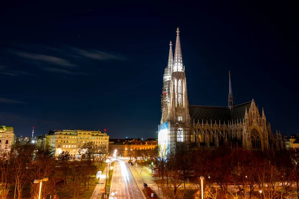 Capital of Austria Vienna at night, view on gothic church and streets of old city