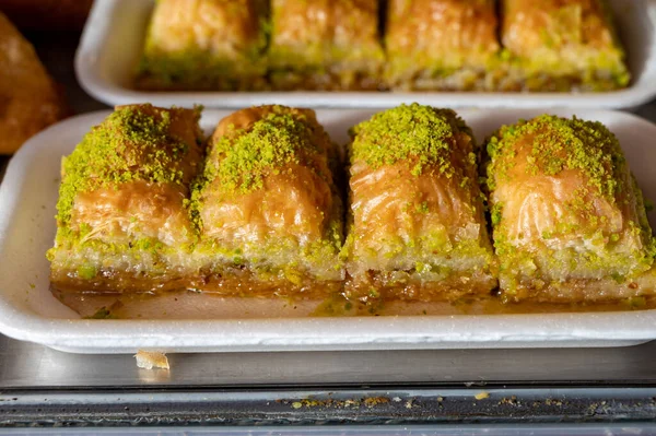 Turkish or arabic sweet dessert, baklava made from filo pastry, filled with chopped pistachio nuts and sweetened with syrup or honey, close up