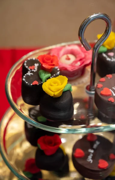 Food styling in bakery, wedding or happy valentine chocolate candies decorated with hearts and flowers on display