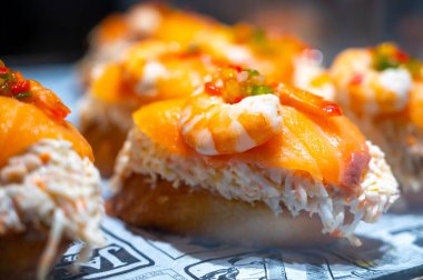 Bask Ülkesi ve Navarre 'ın tipik aperatifleri, Pinchos ya da pinktolar, barda yemeye hazır, soslu ya da malzemeli küçük dilimler, San Sebastian, İspanya, kapatın.