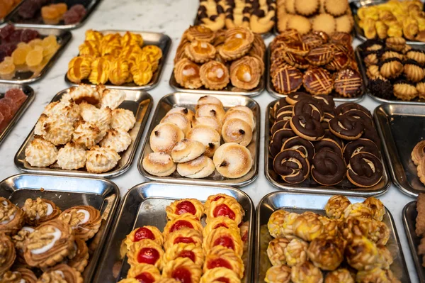 Variety of cookies and cakes on display in artisanal bakery in San Sebastian city, Basque Country, Spain, close up