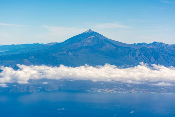 Flying propeller plane around Tenerife island with peak of Mount Teide, volcatic landscape, Canary islands, Spain