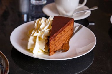 Avusturya kaynaklı kayısı reçelli ünlü Sachertorte çikolatalı pastası. Viyana 'daki eski klasik kafe restoranında kremayla servis ediliyor.