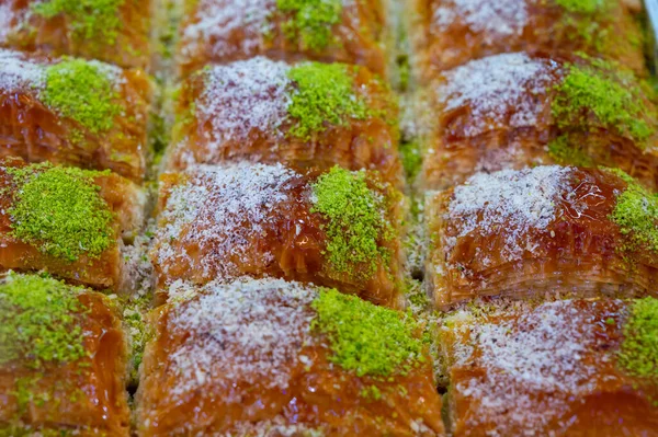 Turkish or arabic sweet dessert, baklava made from filo pastry, filled with chopped pistachio nuts and sweetened with syrup or honey, close up