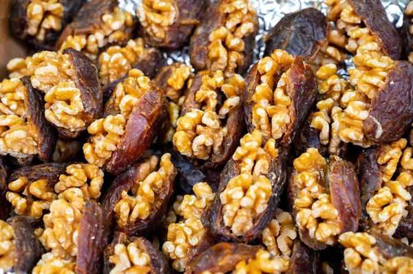 Turkish or arabic sweet dessert, ripe dried dadels with walnuts sweetened with syrup or honey, close up