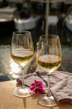 Port Grimaud 'un yat limanında manzaralı soğuk beyaz şarap içmek, Fransa' nın Provence şehrinde Fransız Rivierası 'nda yaz tatili