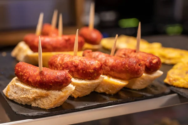 Typical snack in bars of Basque Country and Navarre, pinchos or pinxtos, small slices of bread upon which ingredient or mixture of ingredients is placed and fastened with toothpick, San Sebastian, Spain, close up