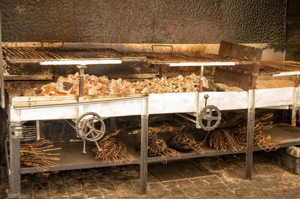 Old charcoal parrillas for fish grilling, build outside of buildings in small fisherman\'s village Getaria, Basque Country, Spain, touristic destination