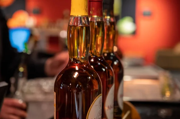 Different ages and colours of strong alcoholic apple drink calvados in Normandy, Calvados region, France, calvados tasting tour