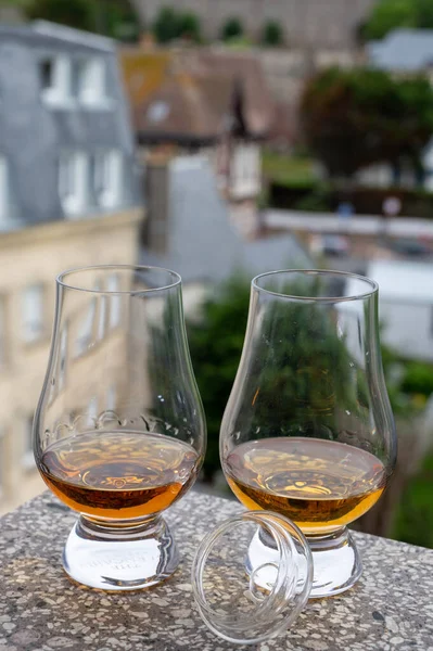 Two drams of scotch whiskey with view on old houses on background, Edinburgh whisky tasting tour, Scotland