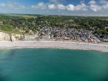 Alçak gelgit dönemi ve okyanusun dibindeki beyaz taşların hava manzarası ve Fransa 'nın Normandiya eyaletindeki Porte d' Aval kemerinin tebeşir kayalıkları. Turistler için tatil yeri.