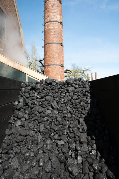 Old-fashioned, non-environmental heating fuel, black rock coal for use in stoking area, air pollution, not eco-friendly