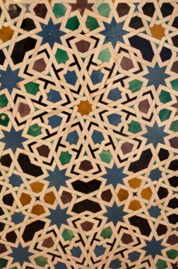 Ornamental medieval ceramic tiles of walls in Nasrid Palaces in the Alhambra palace Granada, Andalusia, Spain. Arabic ornament background wallpaper.