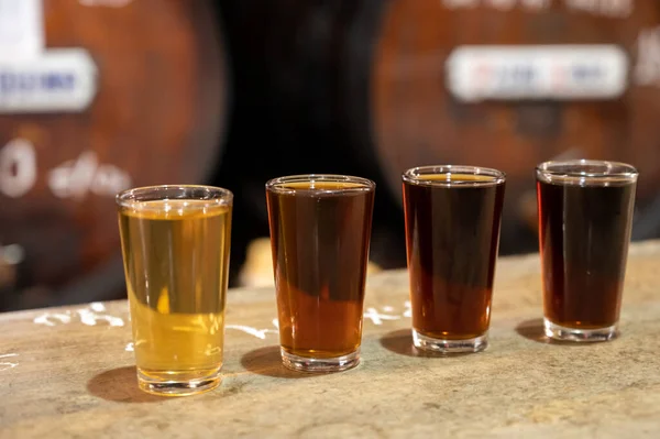 Tasting of different sweet wines from wooden barrels on old bodega wine bar in central part of Malaga, Andalusia, Spain