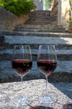 Tasting of red wine by old wine maker in Pierres Dores region with yellow stone houses on south of Beaujolais region France, wine appellation region