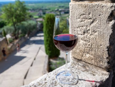 Tasting of red wine by old wine maker in Pierres Dores region with yellow stone houses on south of Beaujolais region France, wine appellation region