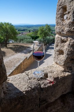 Tasting of red wine by old wine maker in Pierres Dores region with yellow stone houses on south of Beaujolais region France, wine appellation region