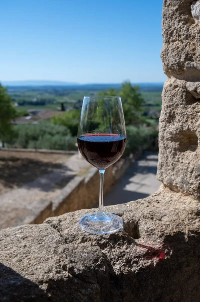 Tasting of red wine by old wine maker in Pierres Dores region with yellow stone houses on south of Beaujolais region France, wine appellation region