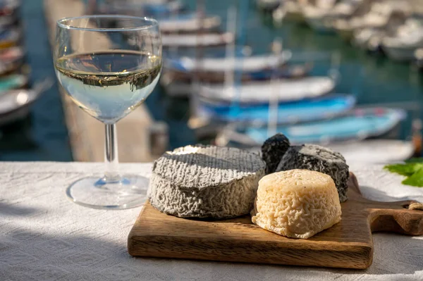Fransız keçi peyniri crottin ve selles-sur-cher Cassis, Provence, Fransa 'nın limanındaki teknelerde sunuldu. Peynir, bir bardak kuru beyaz şarapla tattı.