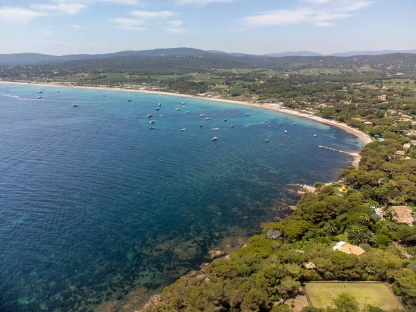Saint-Tropez yakınlarındaki efsanevi Pampelonne plajı ve mavi deniz manzarası Fransız Rivierası 'nın beyaz kumlu sahillerinde yaz tatili.