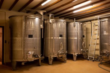 Stages of wine production from fermentation to bottling, visit to wine cellars in Cote d'Or, Burgundy, France, steel vats for fermentation.