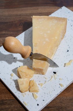 Italian cheese collection, piece of old matured grana padana cheese made from cow milk in Italy, close up