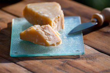 Italian cheese collection, piece of old parmigiano reggiano or parmesan cheese made from cow milk in Parma, north of Italy