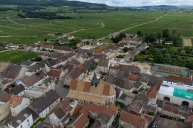 Aerial view on green vineyards and Puligny-Montrachet village, production of high quality famous French white wine in region Burgundy, France