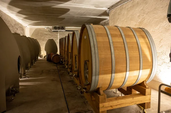 Stages of wine production from fermentation to bottling, visit to wine cellars in Cote d\'Or, Burgundy, France, Aging in wooden barrels.