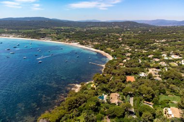 Saint-Tropez yakınlarındaki efsanevi Pampelonne plajı ve mavi deniz manzarası Fransız Rivierası 'nın beyaz kumlu sahillerinde yaz tatili.