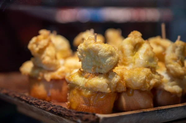 Typical snack in bars of Basque Country and Navarre, pinchos or pinxtos, small slices of bread upon which ingredient or mixture of ingredients is placed and fastened with toothpick, San Sebastian, Spain, close up