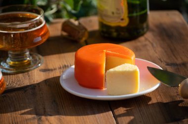 Food and drink pairing, apple cider in glasses produced on organic farm from bio apples in Normandy, France and farmers cheddar cheese from England
