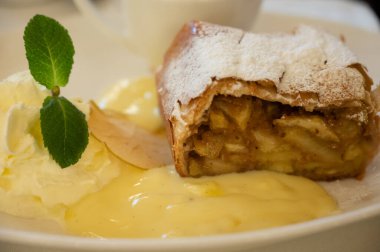 Pouring of txakoli or chacol slightly sparkling very dry white wine produced in Spanish Basque Country, served outdoor with view on Bay of Biscay, Atlantic Ocean