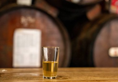Tasting of different sweet wines from wooden barrels on old bodega wine bar in central part of Malaga, Andalusia, Spain