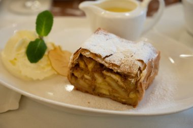 Pouring of txakoli or chacol slightly sparkling very dry white wine produced in Spanish Basque Country, served outdoor with view on Bay of Biscay, Atlantic Ocean