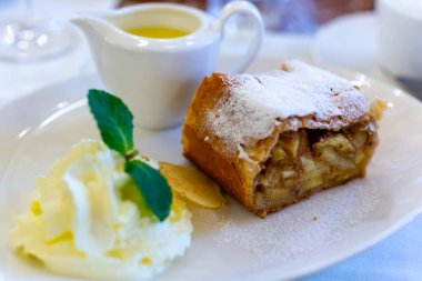 Pouring of txakoli or chacol slightly sparkling very dry white wine produced in Spanish Basque Country, served outdoor with view on Bay of Biscay, Atlantic Ocean