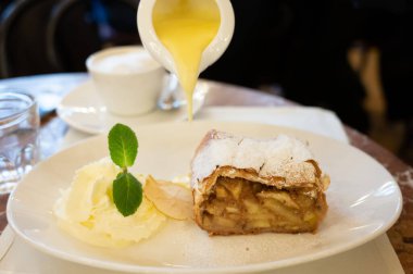 Pouring of txakoli or chacol slightly sparkling very dry white wine produced in Spanish Basque Country, served outdoor with view on Bay of Biscay, Atlantic Ocean