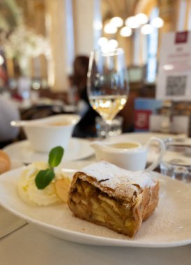 Pouring of txakoli or chacol slightly sparkling very dry white wine produced in Spanish Basque Country, served outdoor with view on Bay of Biscay, Atlantic Ocean