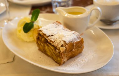 Pouring of txakoli or chacol slightly sparkling very dry white wine produced in Spanish Basque Country, served outdoor with view on Bay of Biscay, Atlantic Ocean