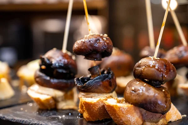 Typical snack in bars of Basque Country and Navarre, pinchos or pinxtos, small slices of bread upon which ingredient or mixture of ingredients is placed and fastened with skewers, San Sebastian, Spain, close up