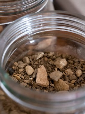 Different samples of soils of Climat of origin areas, grand cru wine tasting in underground cellars caves of French wine domain in Puligny-Motrachet village, Burgundy, France