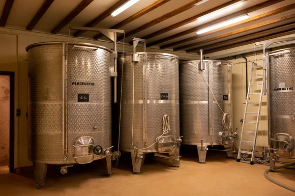 Stages of wine production from fermentation to bottling, visit to wine cellars in Cote d\'Or, Burgundy, France, steel vats for fermentation.